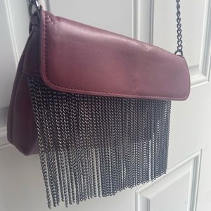 Red crossbody with dangly chain decoration